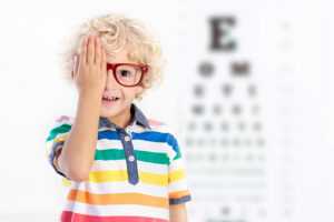 Boy with Glasses Covering One Eye